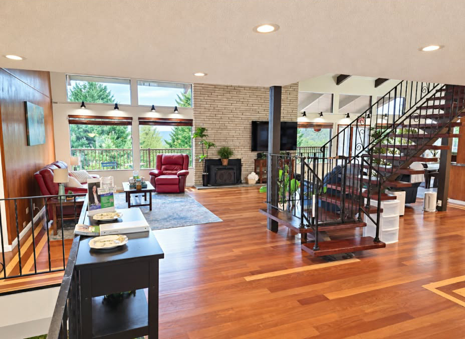 Open main living room with fireplace and staircase